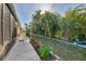 Beautiful backyard with tropical landscaping, a cozy patio, and a meticulously kept lawn at 6796 Gasparilla Pines Blvd # 40, Englewood, FL 34224