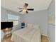 Bedroom featuring wood floors, ceiling fan, and large window at 6796 Gasparilla Pines Blvd # 40, Englewood, FL 34224