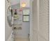Functional laundry room featuring a washer and dryer, storage shelves, and tiled floors at 6796 Gasparilla Pines Blvd # 40, Englewood, FL 34224