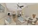 Wide angle view of living room with wood floors, vaulted ceiling, and dining area beyond at 6796 Gasparilla Pines Blvd # 40, Englewood, FL 34224