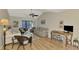 Spacious living room with wood floors, fan, and casual seating at 6796 Gasparilla Pines Blvd # 40, Englewood, FL 34224