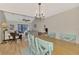 View of living room with vaulted ceiling, fan, wood floors, and access to screened in patio at 6796 Gasparilla Pines Blvd # 40, Englewood, FL 34224