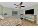 Cozy bedroom with wood floors, ceiling fan, and large window at 6796 Gasparilla Pines Blvd # 40, Englewood, FL 34224
