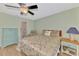 Cozy bedroom featuring wood floors, ceiling fan, and comfortable furnishings at 6796 Gasparilla Pines Blvd # 40, Englewood, FL 34224