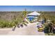 Stunning aerial view of the restaurant, golf carts, and surrounding lush landscape at 7430 Palm Island Dr # 3813, Placida, FL 33946