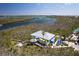 Expansive aerial shot of the restaurant, surrounded by tropical foliage and waterways at 7430 Palm Island Dr # 3813, Placida, FL 33946