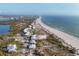 Expansive aerial view of beachfront houses lining the coastline, perfect for a peaceful coastal lifestyle at 7430 Palm Island Dr # 3813, Placida, FL 33946