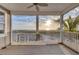 Covered balcony with ocean view, railings, and ceiling fan at 7430 Palm Island Dr # 3813, Placida, FL 33946