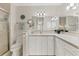 Bright bathroom featuring white cabinetry, neutral tile flooring, shower and modern vanity lighting at 7430 Palm Island Dr # 3813, Placida, FL 33946