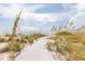 Scenic beach access through dunes, with a clear sky backdrop at 7430 Palm Island Dr # 3813, Placida, FL 33946
