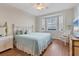 Comfortable bedroom with hardwood floors, neutral decor, and a bright window at 7430 Palm Island Dr # 3813, Placida, FL 33946