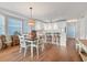 Sun-filled dining area featuring hardwood floors and flows into kitchen and living area at 7430 Palm Island Dr # 3813, Placida, FL 33946