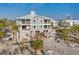 Beautiful elevated beach house featuring large windows, balconies, and stylish coastal design at 7430 Palm Island Dr # 3813, Placida, FL 33946