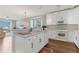 Bright kitchen boasts white cabinetry, marble countertops and flows into a living area with water views at 7430 Palm Island Dr # 3813, Placida, FL 33946