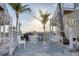 Charming outdoor patio with white furniture, grill, and views of the sun and sky at 7430 Palm Island Dr # 3813, Placida, FL 33946