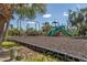 Fun playground area with swings and slides, perfect for families with children in a green setting at 7430 Palm Island Dr # 3813, Placida, FL 33946