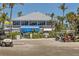 Charming restaurant featuring outdoor seating, palm trees, and convenient golf cart parking at 7430 Palm Island Dr # 3813, Placida, FL 33946