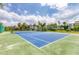 Vibrant tennis court surrounded by lush greenery and beautiful houses, promoting an active lifestyle at 7430 Palm Island Dr # 3813, Placida, FL 33946