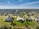 Expansive aerial view of a meticulously landscaped home with a metal roof and a well-maintained lawn at 817 Boundary Blvd, Rotonda West, FL 33947