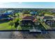 Expansive aerial view of a home with a screened lanai and private boat dock on the water at 8264 Antwerp Cir, Port Charlotte, FL 33981