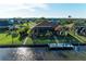Beautiful waterfront home with a screened lanai, dock, and lush tropical landscaping at 8264 Antwerp Cir, Port Charlotte, FL 33981