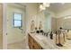 Well-lit bathroom featuring a granite countertop, a vanity, and a mirror at 8264 Antwerp Cir, Port Charlotte, FL 33981