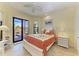 Inviting bedroom with a king-size bed, tray ceiling, and a sliding glass door to the pool area at 8264 Antwerp Cir, Port Charlotte, FL 33981
