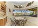 A bright breakfast nook has a chandelier, floral accents, and a built-in cabinet with a granite countertop at 8264 Antwerp Cir, Port Charlotte, FL 33981