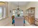 Elegant dining room featuring tray ceiling, chandelier, and windows for natural lighting at 8264 Antwerp Cir, Port Charlotte, FL 33981
