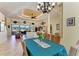 Elegant dining room featuring a chandelier, decorative column and large windows at 8264 Antwerp Cir, Port Charlotte, FL 33981