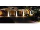 A brick driveway leads to a well-maintained three-car garage, enhanced with landscape lighting for curb appeal and safety at 8264 Antwerp Cir, Port Charlotte, FL 33981