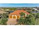 Stunning waterfront home with a three-car garage, lush landscaping, and beautiful terracotta roof at 8264 Antwerp Cir, Port Charlotte, FL 33981