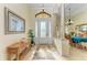 Elegant foyer featuring tile flooring, decorative columns, and a stylish front door with sidelights at 8264 Antwerp Cir, Port Charlotte, FL 33981