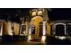 Stunning home entrance with elegant columns, decorative features, and landscape lighting enhancing its curb appeal at night at 8264 Antwerp Cir, Port Charlotte, FL 33981