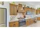 This kitchen features stainless steel appliances, granite countertops, tile backsplash, and beautiful custom cabinetry at 8264 Antwerp Cir, Port Charlotte, FL 33981