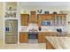 Well-lit kitchen features stainless steel appliances, granite countertops, custom cabinetry, and tile backsplash at 8264 Antwerp Cir, Port Charlotte, FL 33981