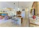 Open-concept kitchen featuring stainless steel appliances, granite island, custom cabinets, and an open plan to the living room at 8264 Antwerp Cir, Port Charlotte, FL 33981
