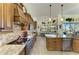 Bright kitchen showcasing stainless appliances, granite counters, tiled floors, and views to a bright dining area at 8264 Antwerp Cir, Port Charlotte, FL 33981