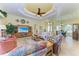 Bright living room with tile flooring, tray ceiling, and plenty of natural light at 8264 Antwerp Cir, Port Charlotte, FL 33981