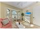 Bright living room with tile flooring, large windows with plantation shutters, and comfortable seating at 8264 Antwerp Cir, Port Charlotte, FL 33981