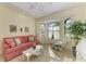 Comfortable living room featuring neutral tones, tile floors, a bay window, and stylish furnishings at 8264 Antwerp Cir, Port Charlotte, FL 33981