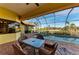 Inviting patio area with comfortable seating overlooking a screened-in pool and spa at 8264 Antwerp Cir, Port Charlotte, FL 33981