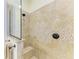 Elegant tiled shower featuring glass doors, a built-in seat, a shower head, and decorative accents at 8264 Antwerp Cir, Port Charlotte, FL 33981