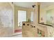 Spacious tiled shower with glass block window, built-in shelves, and a rain shower head at 8264 Antwerp Cir, Port Charlotte, FL 33981
