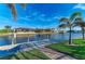 Scenic waterfront view featuring a private dock, lush landscaping, and serene water views at 8264 Antwerp Cir, Port Charlotte, FL 33981
