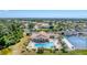 A scenic aerial view of a community pool, tennis courts, and well-maintained grounds of the property at 8356 Creekview Ln, Englewood, FL 34224