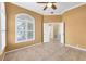 A versatile room features tile flooring, a large arched window with shutters, and an open doorway at 8356 Creekview Ln, Englewood, FL 34224