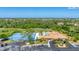 Aerial view of community amenities featuring pool, tennis court and golf course at 8356 Creekview Ln, Englewood, FL 34224
