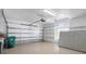 Spacious two car garage with epoxy floor, overhead storage and extra shelving at 8356 Creekview Ln, Englewood, FL 34224