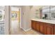 Hallway features a built-in bar area with wooden cabinets and glass shelves, leading to living spaces at 8356 Creekview Ln, Englewood, FL 34224